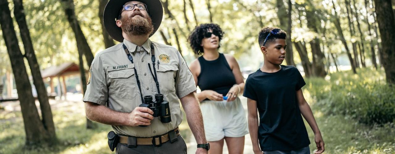 park ranger and kids looking at nature